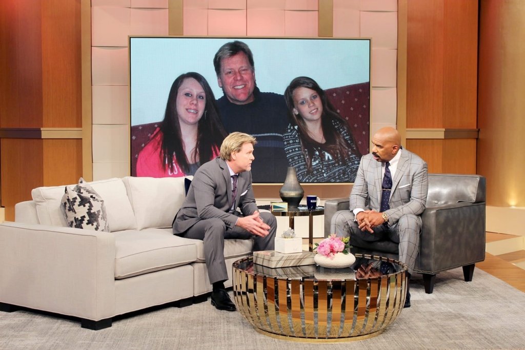 On the Steve Harvey show discussing my book, But Dad. That's me and my two daughters, featured on the wall.